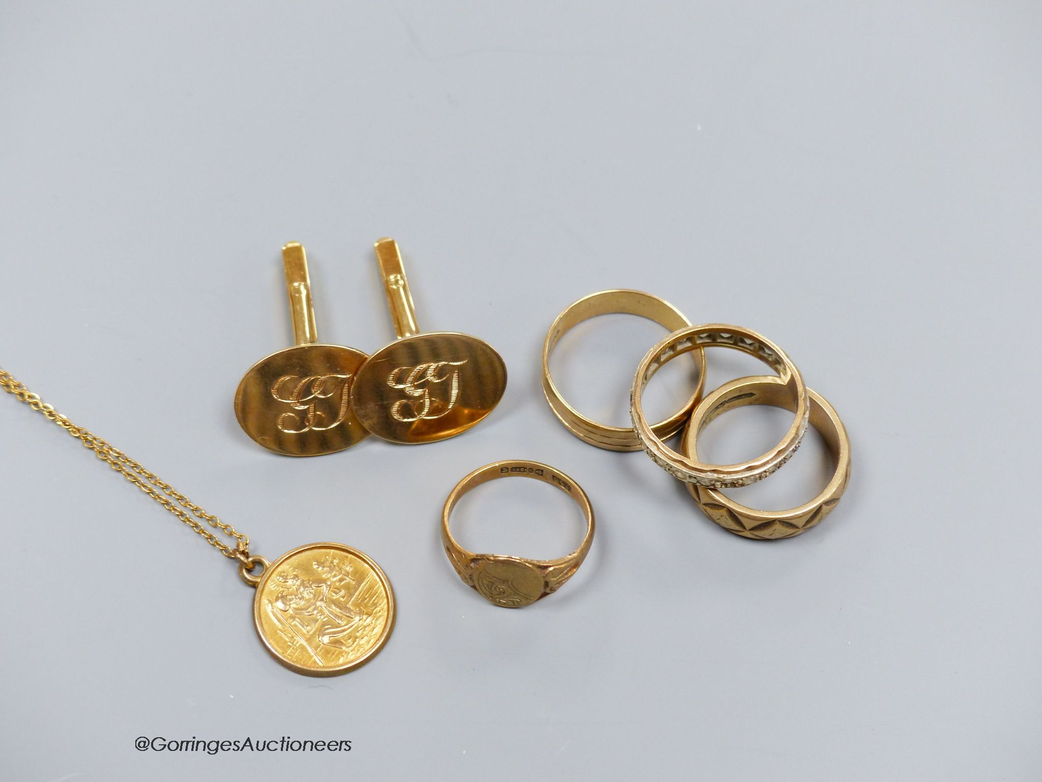 A pair of 9ct gold oval cufflinks with engraved initials, three various 9ct gold rings including paste set and a 9ct gold St Christopher pendant on gilt chain, gross 22.6g. total approx 20g